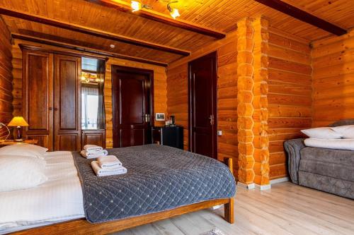 a bedroom with a bed and a couch in a room at Villa Elena SPA & Resort in Bukovel