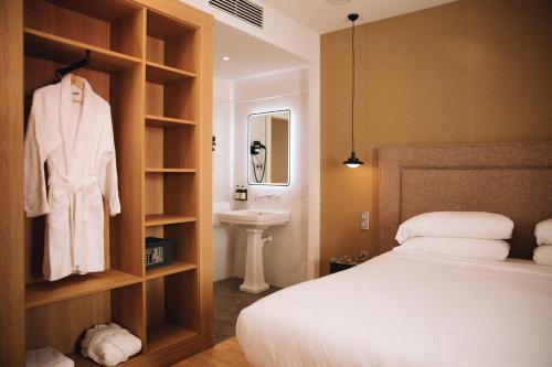 um quarto com uma cama e um lavatório num quarto em H La Paloma Boutique em Barcelona