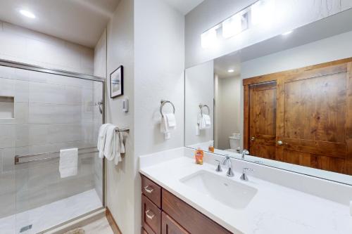 a bathroom with a sink and a shower and a mirror at Pend Oreille Hideaway in Dover