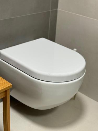 a white toilet in a bathroom with a table at Mi AN HOME in Paese