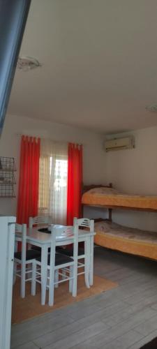 a room with a table and chairs and a bed at Apartman in Nikšić