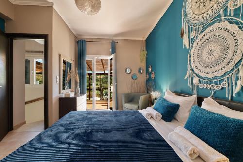 a bedroom with a large bed with blue walls at Villa Fisi and Wellness in Apladhianá