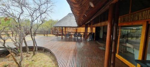 a wooden deck with a gazebo on a house at Livingstone Bush Lodge, Mabalingwe in Bela-Bela