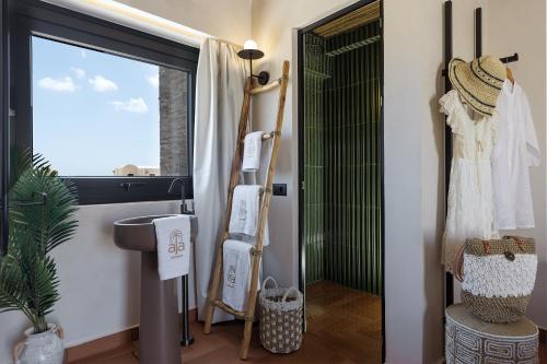 a bathroom with a shower and a toilet and a sink at Aja Retreat Luxury Suites in Kamari