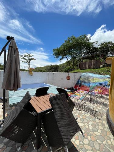 a patio with a table and chairs and an umbrella at La Bota del Gigante in Gigante