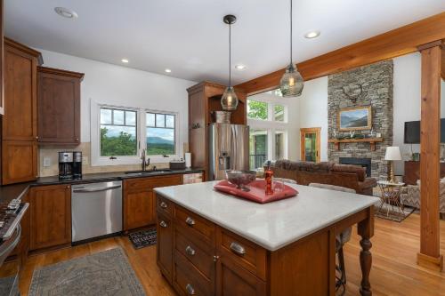 a kitchen with a island in the middle of a room at Frolly Falls in Black Mountain