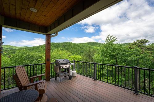 a grill on a deck with a view of the mountains at Frolly Falls in Black Mountain