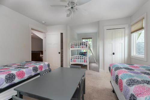 a bedroom with two beds and a table at Frolly Falls in Black Mountain