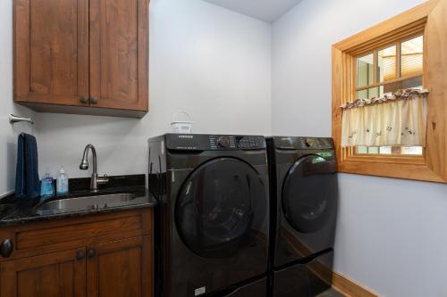 a black washer and dryer in a kitchen at Frolly Falls in Black Mountain