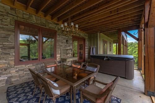 a dining room with a table and chairs and a piano at Frolly Falls in Black Mountain