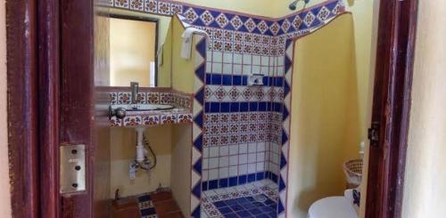 a bathroom with a sink and a mirror at Posada Las Flores in Los Ayala