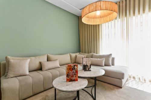 a living room with a couch and two tables at Serene One Bed Oasis in the Heart Of The Medina in Les Camps