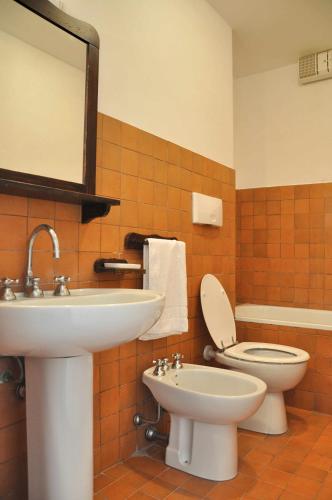 a bathroom with a sink and a toilet and a mirror at Montecasciano - Ortensia in Capranica