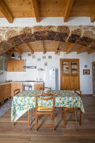 a kitchen with a table and chairs in a room at Home at Calascio in Calascio
