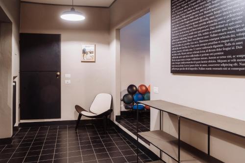 a hallway with a table and a chair and balloons at BirBo Bike Hospitality in Siena