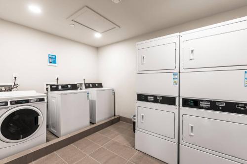 a laundry room with white cabinets and a washer and dryer at Black Rock Ridge 14488 by Moose Management in Park City