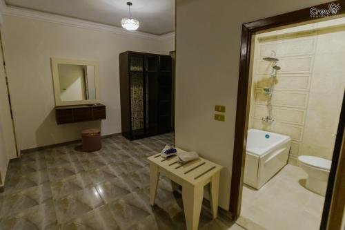 a bathroom with a toilet and a table in it at Pyramids Golden Gate Hotel - Full Pyramids View & Roof Top in Cairo
