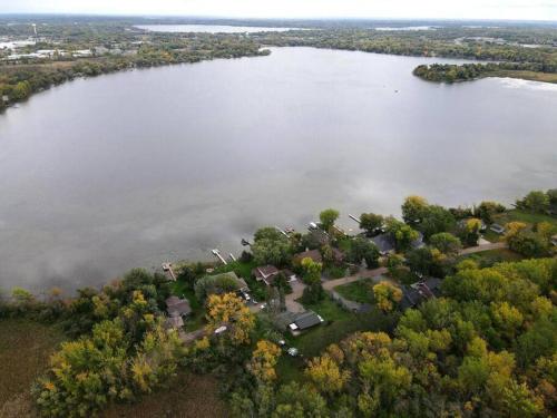 an aerial view of a house on the shore of a lake at The Clear Lake Retreat in Forest Lake