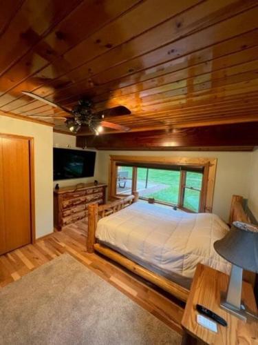 a bedroom with a bed and a wooden ceiling at The Clear Lake Retreat in Forest Lake