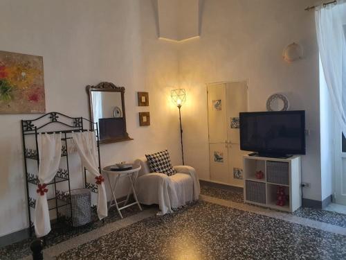 a living room with a tv and a chair at Appartamento Patty in Cannole