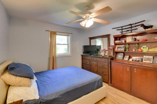 a bedroom with a bed and a dresser and a ceiling fan at Peaceful Lake Hartwell Gem with Boat Dock in Martin