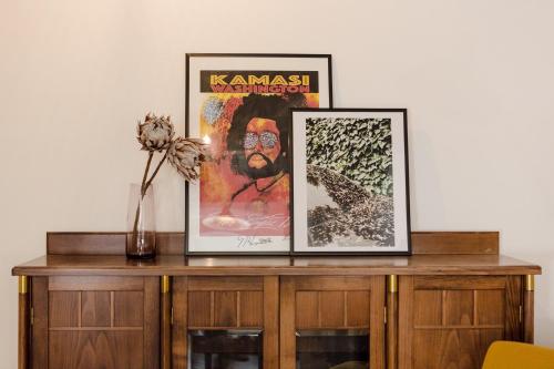 two framed pictures on top of a wooden cabinet at Marktplatz-Residenz - 110 m vom Traunsee in Gmunden