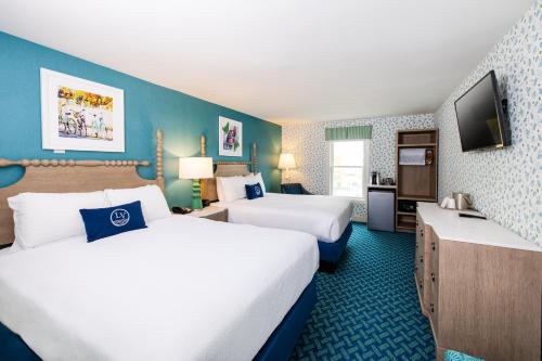 a hotel room with two beds and a television at Lake View Hotel in Mackinac Island