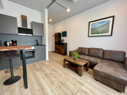 a living room with a couch and a table at Wunderschönes Apartment am Schlössle Zentrum Pforzheim in Pforzheim