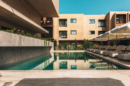 a swimming pool in front of a building at M Boutique Hotel - Designed for Adults in Paphos City