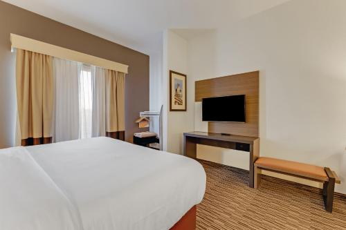 a hotel room with a bed and a television at Comfort Suites Murfreesboro Shopping District in Murfreesboro