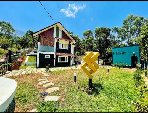 a yellow arrow sign in front of a house at Black stone in Chinnakanal