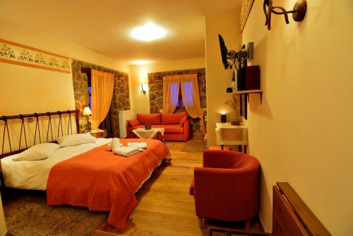 a bedroom with a bed and a living room at Mavraganeiko in Synikia Mesi Trikalon