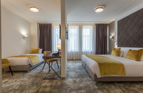 A bed or beds in a room at Leonardo Boutique Hotel Budapest M-Square