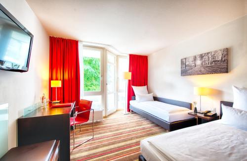 慕尼黑的住宿－萊昂納多酒店慕尼黑市西，酒店客房带红色窗帘的卧室