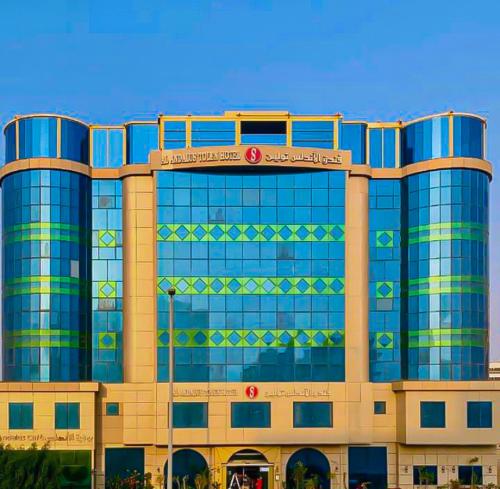 a large glass building with a sign on it at Al Andalus Tolen Hotel in Jeddah
