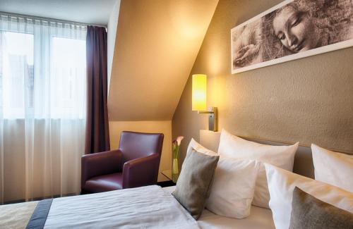Ένα ή περισσότερα κρεβάτια σε δωμάτιο στο Leonardo Hotel Mannheim-Ladenburg