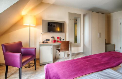Ένα ή περισσότερα κρεβάτια σε δωμάτιο στο Leonardo Hotel Mannheim-Ladenburg