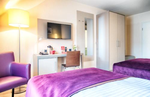 Ένα ή περισσότερα κρεβάτια σε δωμάτιο στο Leonardo Hotel Mannheim-Ladenburg