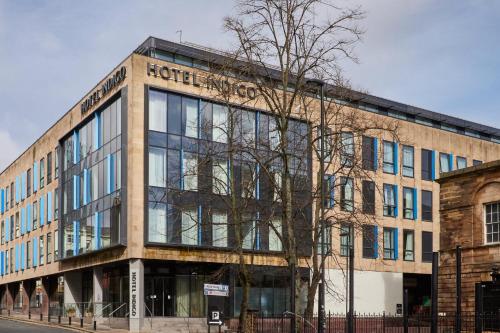 a brick building with a tree in front of it at Hotel Indigo Newcastle by IHG in Newcastle upon Tyne
