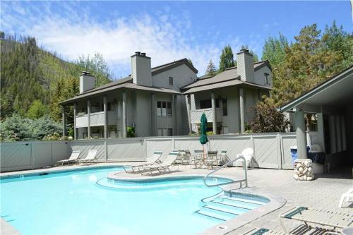 a house with a swimming pool in front of a house at Greyhawk Condo 07 in Ketchum