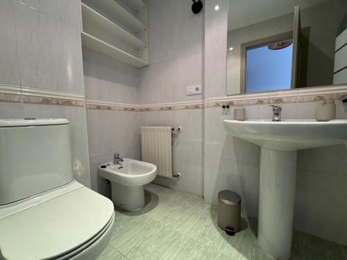 a bathroom with a toilet and a sink at O Faiado Da Ria By Oktheway in Culleredo