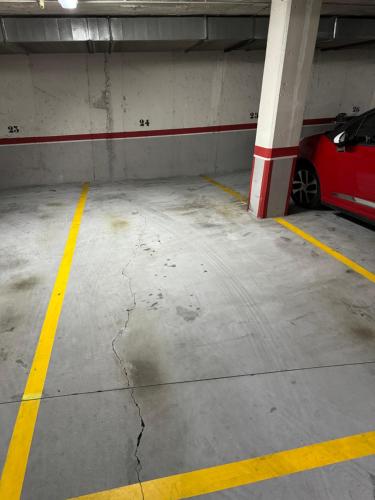 a parking garage with a red car parked in it at O Faiado Da Ria By Oktheway in Culleredo