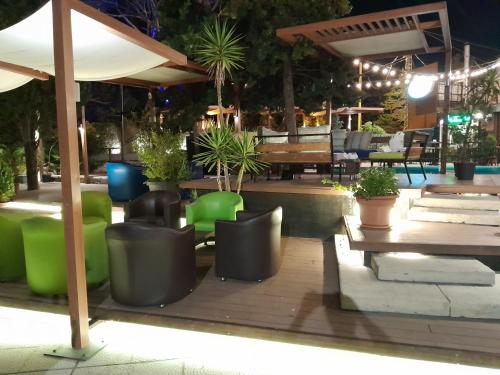 a patio with chairs and tables at night at GARDEN HOTEL in Broummana