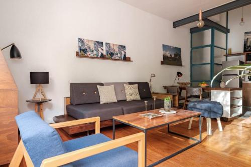 a living room with a couch and a table at Bright & Stylish Apt With Balcony Reforma Avenue in Mexico City