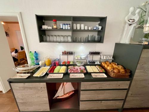 a table with different types of food on it at Pension Haus My in Norddeich