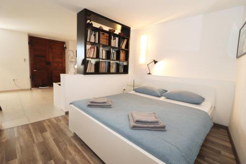 a bedroom with a large bed with towels on it at Apartment Istra in Poreč