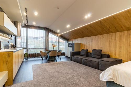 a bedroom with a couch and a table in a room at Shelter Apart Hotel in Bukovel