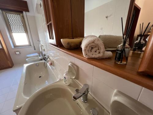 a bathroom with a sink and a bath tub at Nonna Ciccina’s House in Vita