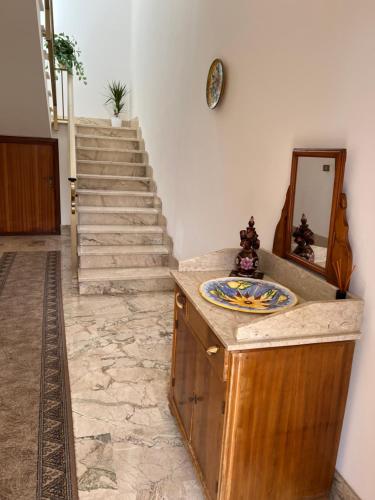 a room with a staircase and a counter with a sink at Nonna Ciccina’s House in Vita