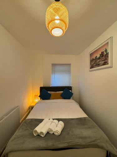 a bedroom with a bed with two towels on it at Manor Court in London